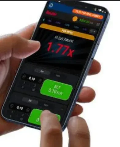 Смартфон в руке, на экране краш-игра с множителем 1.77x
